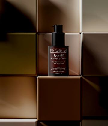 A bottle of anti-aging serum sits on squares.
