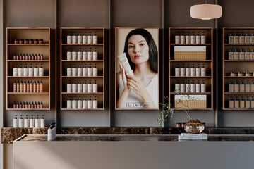 Woman holding skincare product in beauty store