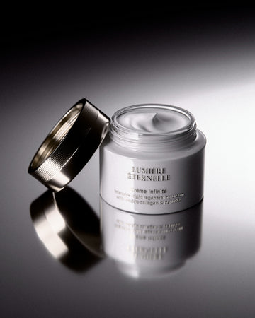 Jar of luxurious white face cream with silver lid.