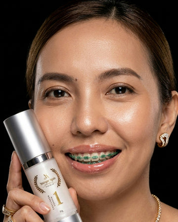Woman holding a skincare product with a black background